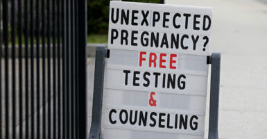 A sign outside a crisis pregnancy center reads “Unexpected Pregnancy? Free Testing & Counseling.”