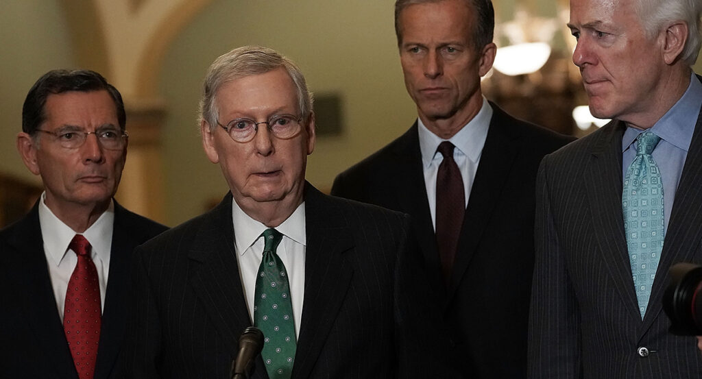 John Barrasso, Mitch McConnell, John Thune, and John Cornyn stand in suits