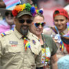 Boy Scouts in uniform march in pride parade