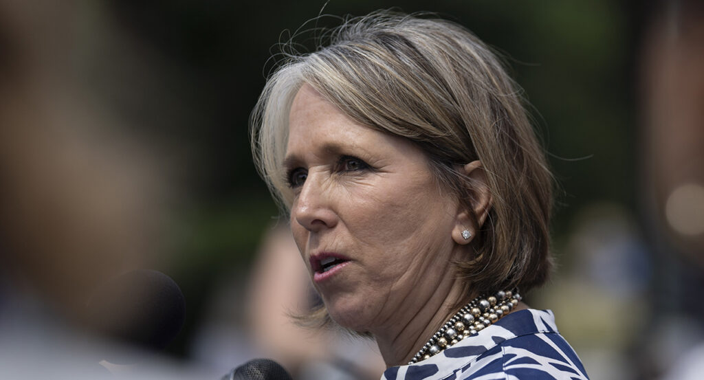 Michelle Lujan Grisham wearing a pearl necklace and earrings
