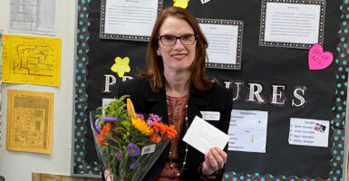 Elizabeth Mirabelli holds a thank-you card in her classroom.
