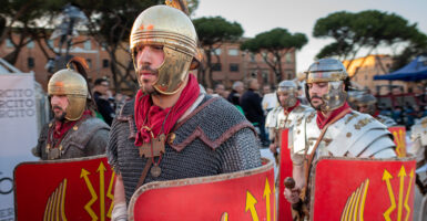 Mean wear chain mail and carry shields reminiscent of legions in the Roman Empire.