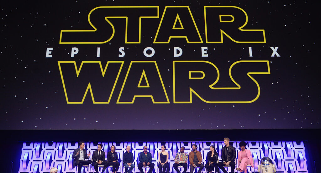 The cast of Star Wars: The Rise of Skywalker beneath a banner reading "Star Wars: Episode IX"