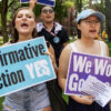 Students hold signs protesting for affirmative action