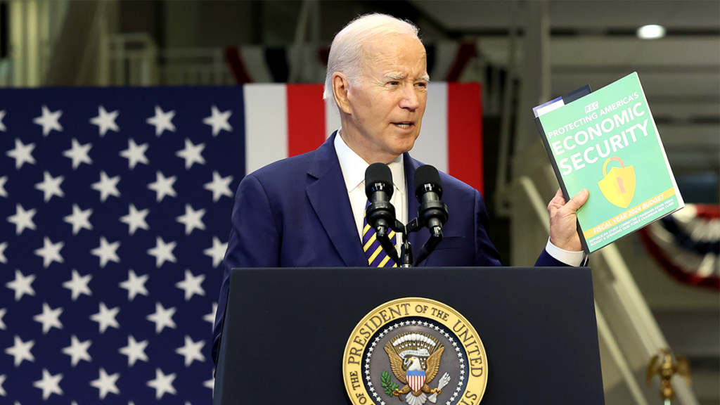 Joe Biden speaking at a podium with the presidential seal