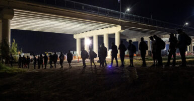 Illegal aliens under an overpass after crossing the border from Mexico into the U.S.