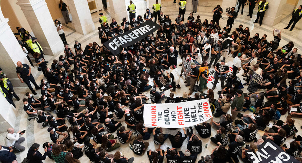 Protesters occupy the Cannon House Office Building rotunda with signs reading "Ceasefire"