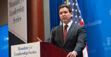 Ron DeSantis speaks in front of a podium at The Heritage Foundation