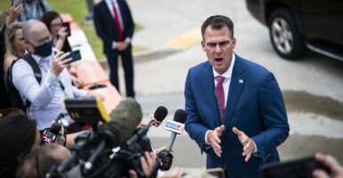 Republican Oklahoma Gov. Kevin Stitt slammed a lawsuit against the nation's first religious charter school as a "political stunt" during an interview with The Daily Signal. Pictured: Stitt speaks to reporters outside before President Donald J. Trump arrives for a "Make America Great Again!" rally at the BOK Center on Saturday, June 20, 2020 in Tulsa, OK. (Photo: Jabin Botsford/The Washington Post/Getty Images)
