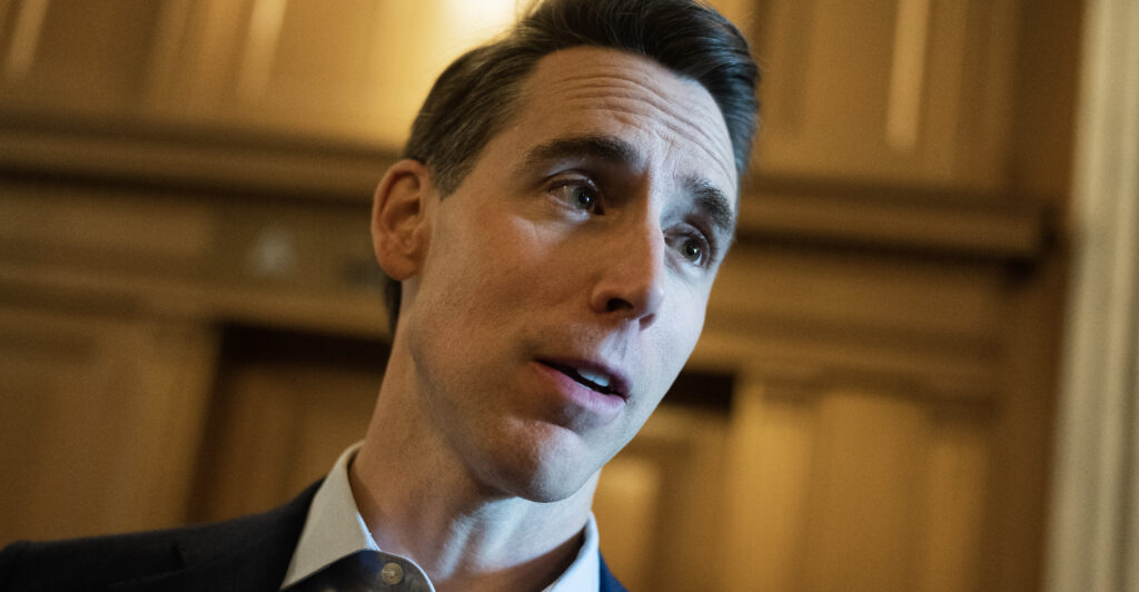 Josh Hawley in the halls of Congress wearing a collared shirt