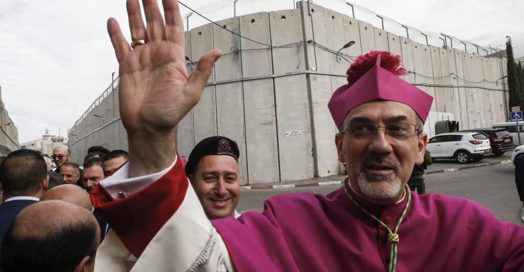 The Latin Patriarch of Jerusalem reportedly said Monday that he would go to great lengths to obtain the freedom of those children captured by Hamas terrorists, even offering himself as an exchange for their safety. Pictured: Archbishop Pierbattista Pizzaballa, Apostolic Administrator of the Latin Patriarchate of Jerusalem, gestures upon arrival through an Israeli checkpoint to attend Christmas eve celebrations in the West Bank city of Bethlehem December 24, 2017. (Photo by HAZEM BADER/AFP via Getty Images)