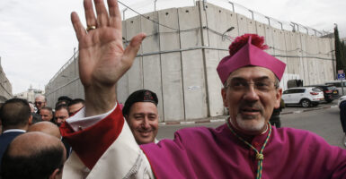 The Latin Patriarch of Jerusalem reportedly said Monday that he would go to great lengths to obtain the freedom of those children captured by Hamas terrorists, even offering himself as an exchange for their safety. Pictured: Archbishop Pierbattista Pizzaballa, Apostolic Administrator of the Latin Patriarchate of Jerusalem, gestures upon arrival through an Israeli checkpoint to attend Christmas eve celebrations in the West Bank city of Bethlehem December 24, 2017. (Photo by HAZEM BADER/AFP via Getty Images)