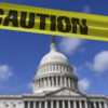 The US capitol building is photographed with yellow caution tape.