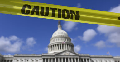 The US capitol building is photographed with yellow caution tape.