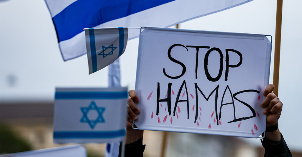 Demonstrators wave Israeli flags and a "Stop Hamas" sign to show their solidarity with Israel