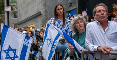 Supporters of Israel hold Israeli flags at a vigil in New York City