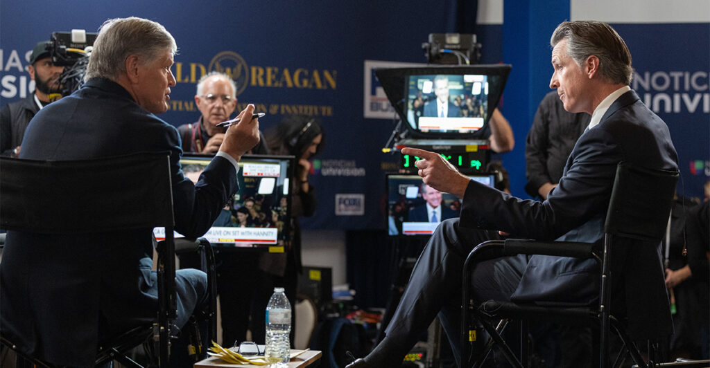 Gov. Gavin Newsom sits in an interview with Fox News’ Sean Hannity