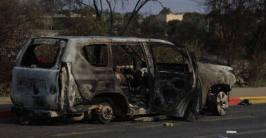 A burned car sits of the road in Israel following Hamas' attack on Israel.