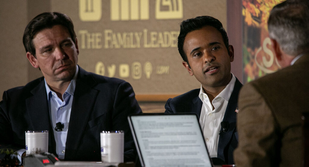 Ron DeSantis and Vivek Ramaswamy in suits without ties in front of a "The Family Leader" logo