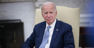 President Joe Biden scowls in a blue suit