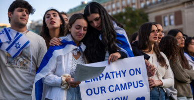 Jewish students and supporters comfort one another at a rally