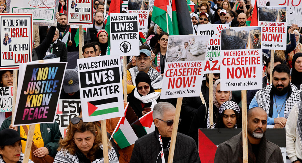 Protesters march with signs reading "Palestinian Lives Matter" and "Michigan Says Ceasefire Now"