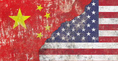 Chinese and USA flags on textured wall background