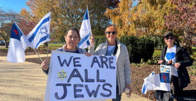 two women hold a sign that reads "we are all jews"