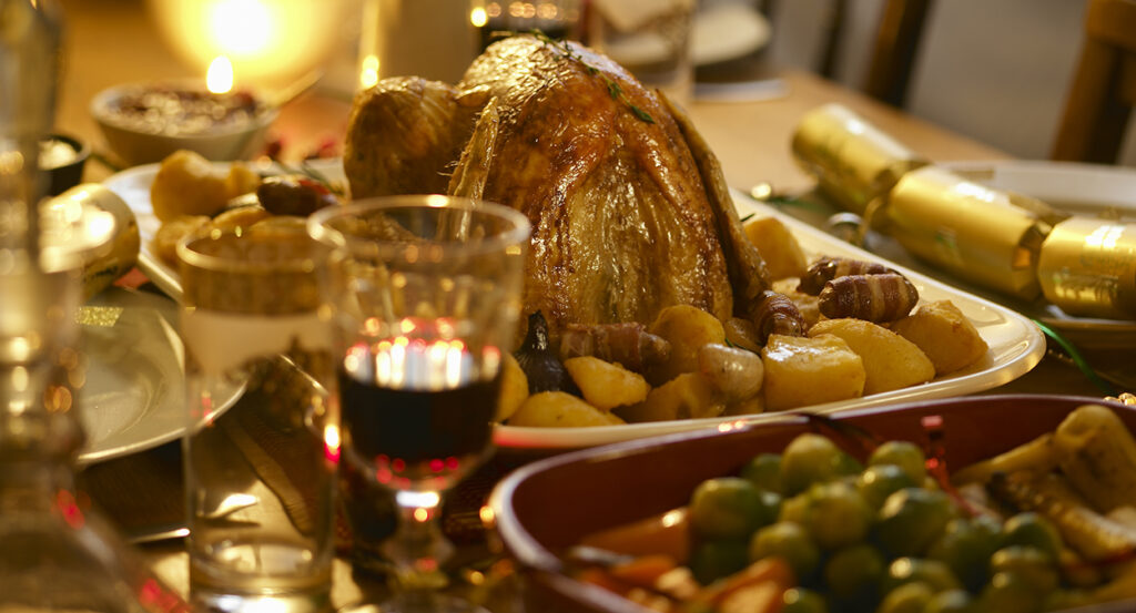 Turkey, wine, and other food at a Christmas dinner table