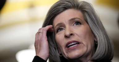 Iowa Senator Joni Ernst brushes back her silver hair