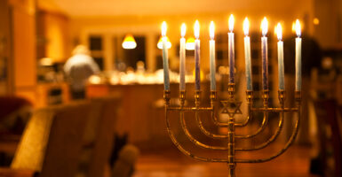 A menorah is seen fully lit in someones home.