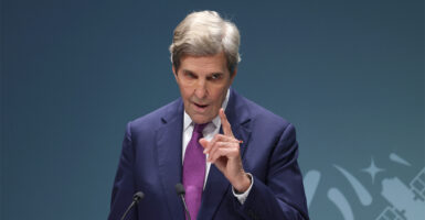 U.S. Climate Envoy John Kerry speaks to an audience while wagging his finger