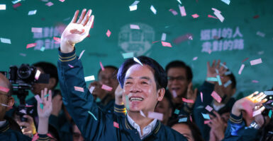 President-elect Lai Ching-te waves to the crowd as confetti falls during his victory speech.