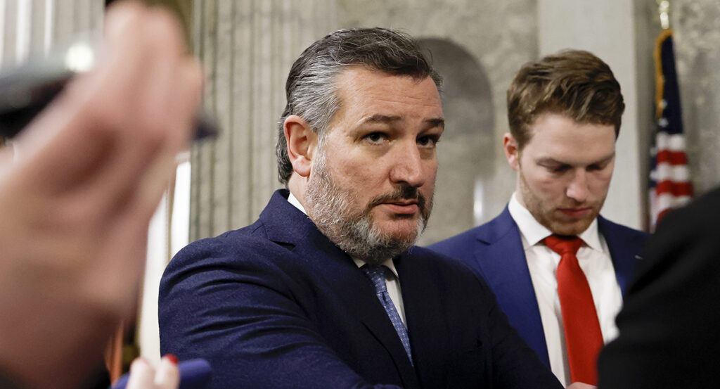 Sen. Ted Cruz stares intently while wearing a blue suit