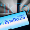 A phone displays the "ByteDance" name in front of the words "TikTok" glowing in blue and red.