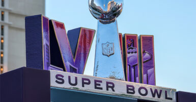 A large stand showing the words LVII and Super Bowl with the Lombardi Trophy.