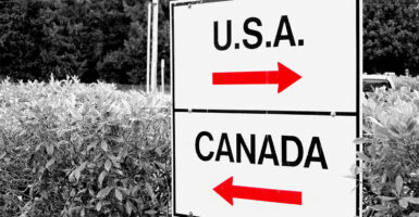 Signs pointing to USA and Canada at the U.S.-Canada border.