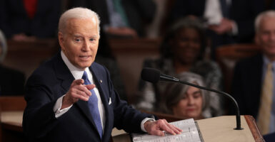 President Joe Biden looks to his side and points while giving the State of the Union.