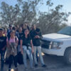 A group of illegal immigrants stand on the side of the road next to a Border Patrol truck.