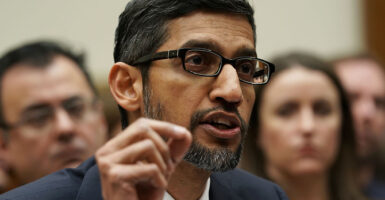 Google CEO Sundar Pichai in a suit with a salt-and-pepper beard speaks