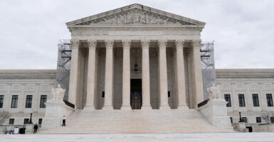 The Supreme Court building in the U.S. with classical pillars and scaffolding on either side of the entryway