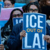 A group of activist Protesters holding up signs saying "ICE out of LA"