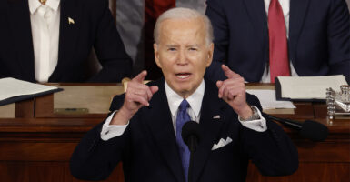 President Biden Delivers State Of The Union Address, raising both arms to emphasize a point