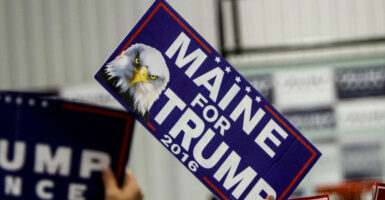 A "Maine for Trump 2016" sign held by a supporter at a campaign rally.