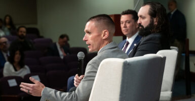 FBI agents Stephen Friend and Garret O'Boyle speak with Rep. Jason Chaffetz, wearing suits
