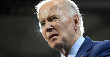 Biden looks ahead in a suit and tie.