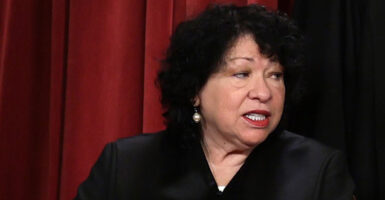 Supreme Court Justice Sonia Sotomayor prepares to pose for a photo in her black robe