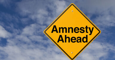 Road sign that says "Amnesty Ahead"
