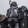 pro-Hamas protesters wrap Palestinian flag and Keffiye around the statue