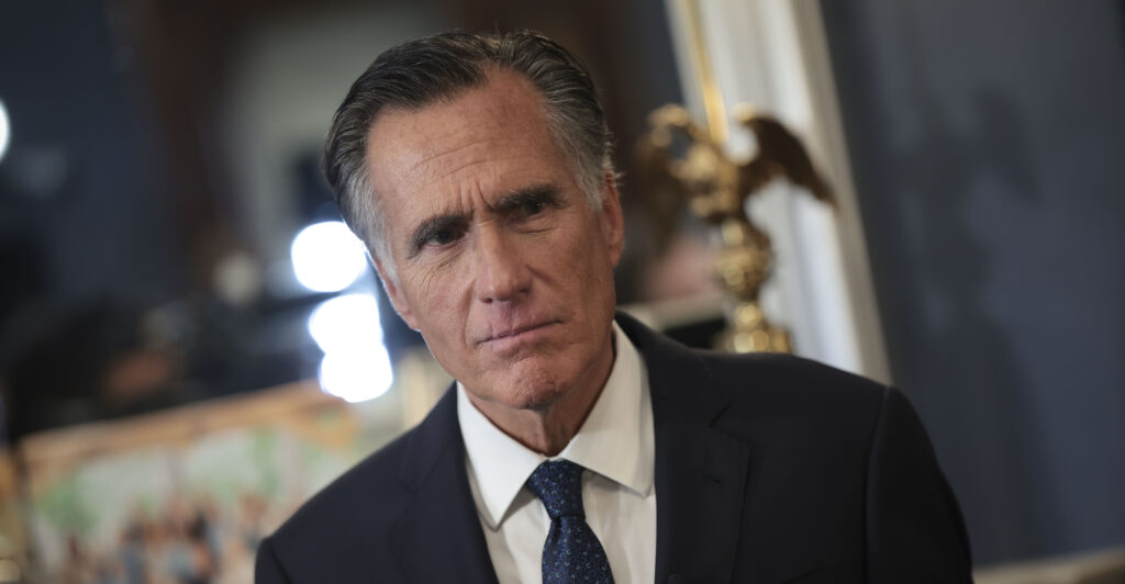 Sen. Mitt Romney, R-Ut., frowns and wears a suit and tie.